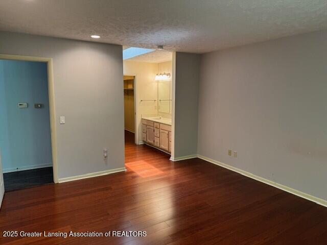 2434 Emerald Lake Dr, East Lansing, MI 48823 - empty room featuring dark wood-style floors, recessed lighting, and a textured ceiling