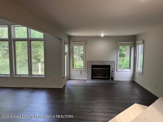 2434 Emerald Lake Dr, East Lansing, MI 48823 - unfurnished living room with a fireplace with flush hearth and dark wood-type flooring