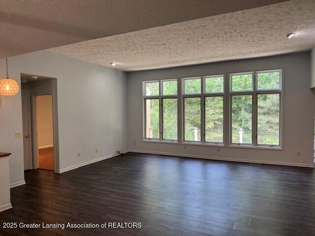 2434 Emerald Lake Dr, East Lansing, MI 48823 - empty room featuring a textured ceiling and dark wood-style flooring