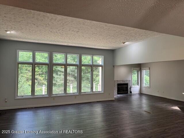2434 Emerald Lake Dr, East Lansing, MI 48823 - unfurnished living room featuring a textured ceiling, dark wood-style flooring, and a fireplace