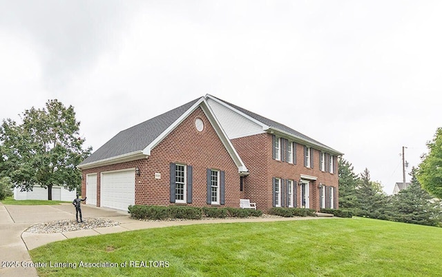 8505 W Willow Hwy, Grand Ledge, MI 48837 - colonial inspired home with brick siding, a front lawn, and driveway