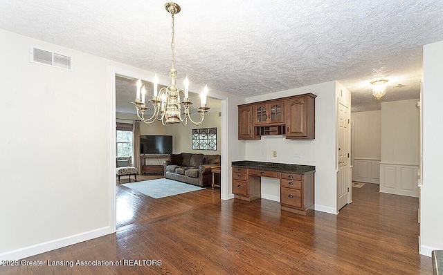 8505 W Willow Hwy, Grand Ledge, MI 48837 - dining area with a chandelier, a textured ceiling, dark wood-style flooring, and baseboards
