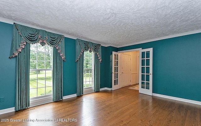 8505 W Willow Hwy, Grand Ledge, MI 48837 - unfurnished room featuring a textured ceiling, wood finished floors, french doors, baseboards, and crown molding