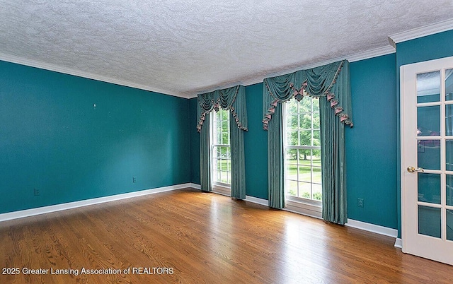 8505 W Willow Hwy, Grand Ledge, MI 48837 - empty room with a textured ceiling, crown molding, wood finished floors, and baseboards