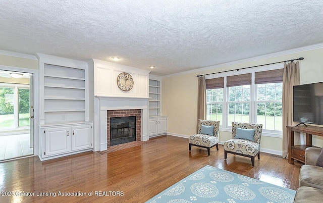 8505 W Willow Hwy, Grand Ledge, MI 48837 - living area featuring dark wood-type flooring, plenty of natural light, a textured ceiling, a fireplace, and ornamental molding