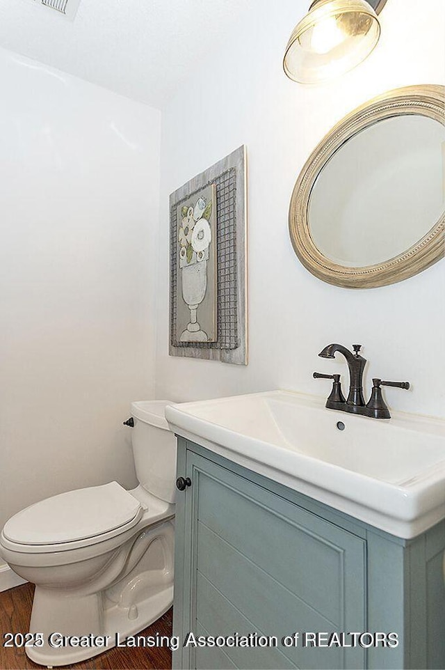 8505 W Willow Hwy, Grand Ledge, MI 48837 - bathroom with vanity, toilet, and wood finished floors