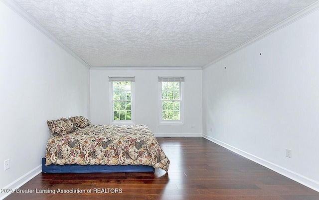 8505 W Willow Hwy, Grand Ledge, MI 48837 - bedroom with wood finished floors, ornamental molding, a textured ceiling, and baseboards