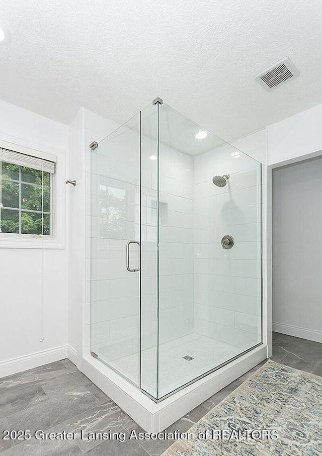 8505 W Willow Hwy, Grand Ledge, MI 48837 - bathroom with baseboards, a shower stall, and a textured ceiling