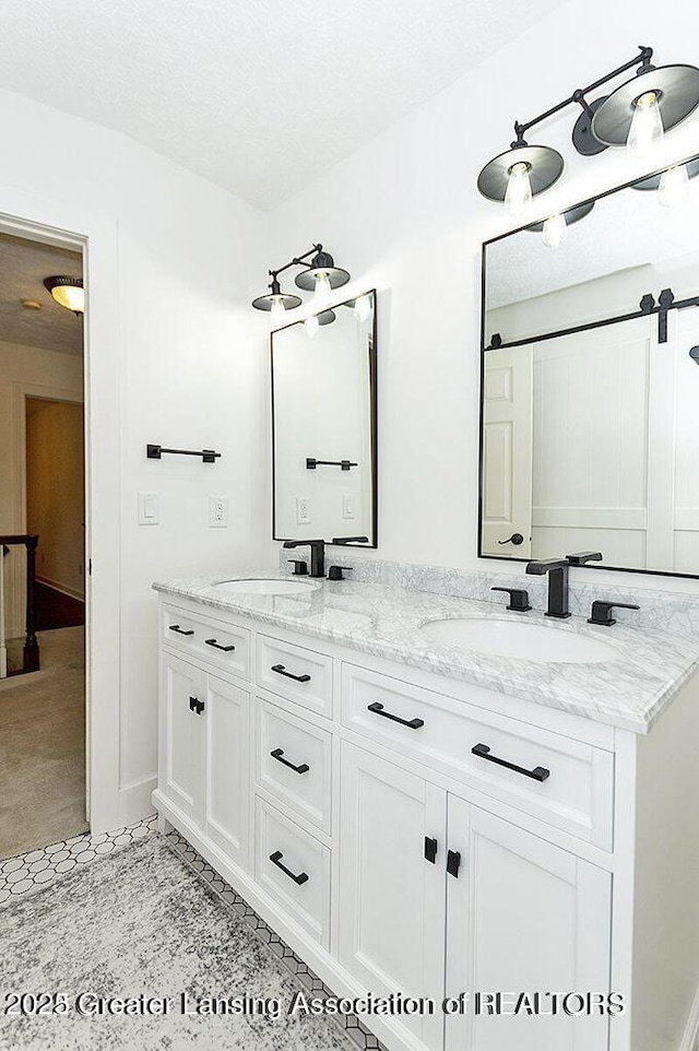 8505 W Willow Hwy, Grand Ledge, MI 48837 - full bath featuring double vanity and a textured ceiling