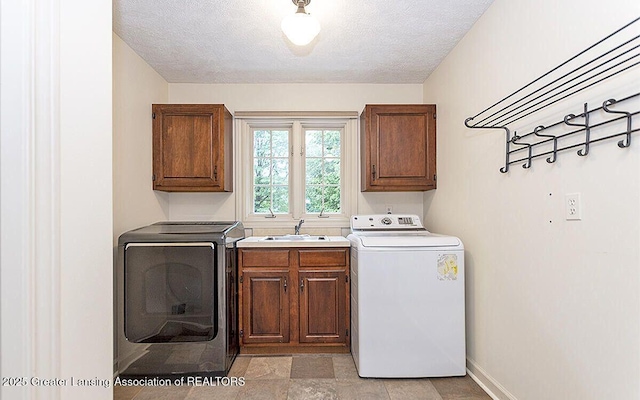 8505 W Willow Hwy, Grand Ledge, MI 48837 - washroom featuring washer / clothes dryer, cabinet space, baseboards, and a textured ceiling