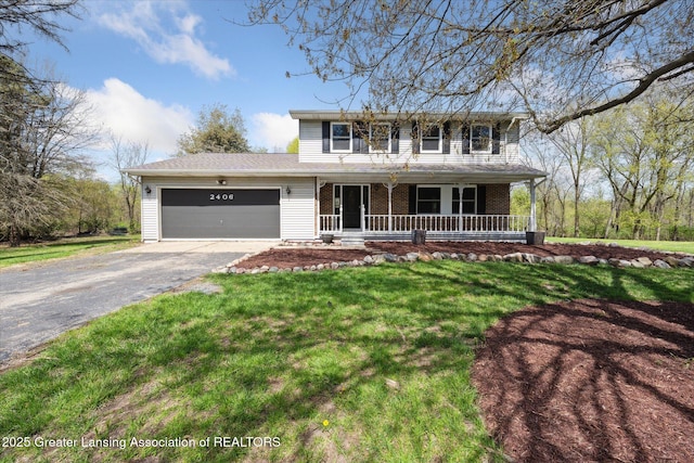 traditional-style home featuring covered porch, aphalt driveway, a garage, brick siding, and a front lawn