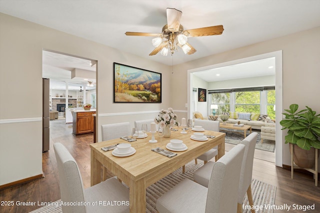 dining room with a ceiling fan and wood finished floors