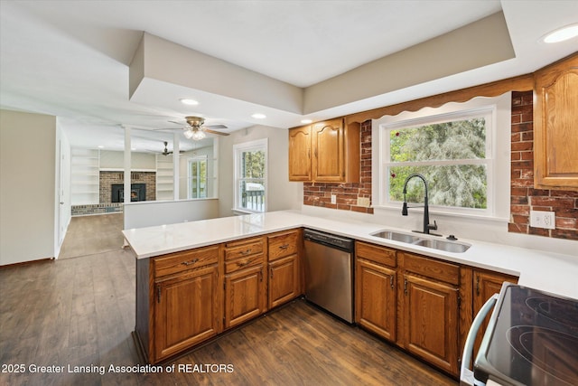 kitchen with stainless steel dishwasher, electric range, a peninsula, ceiling fan, and a sink