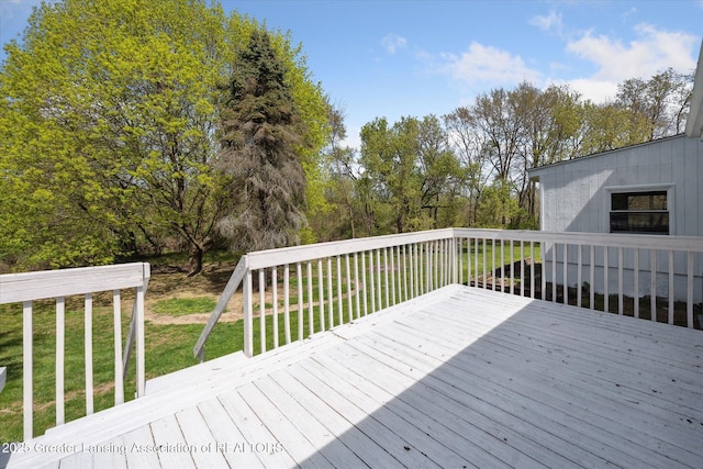 wooden terrace featuring a lawn