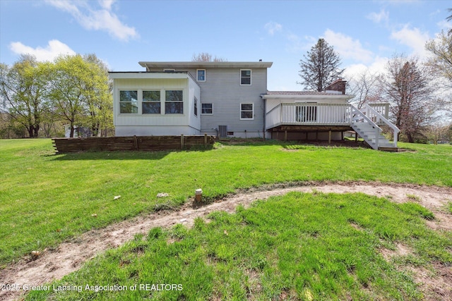 rear view of house with stairway, a yard, fence, and a wooden deck