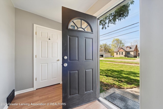entrance foyer with baseboards and light wood-type flooring