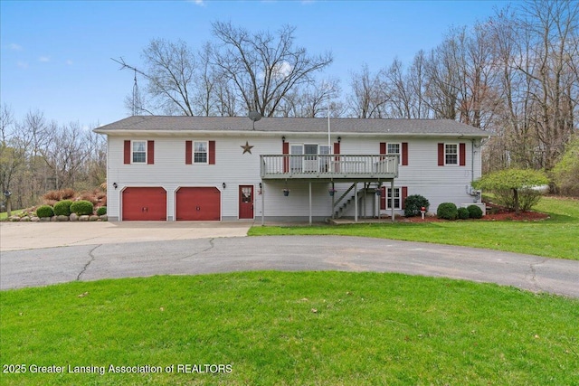 view of front facade featuring driveway, a front yard, a wooden deck, a garage, and stairway