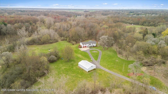 birds eye view of property featuring a wooded view