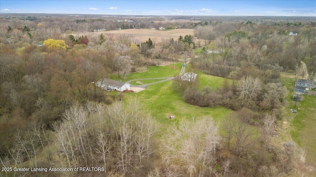drone / aerial view featuring a forest view