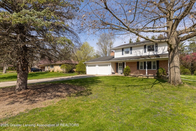 traditional-style house featuring a shingled roof, a front lawn, brick siding, a garage, and driveway