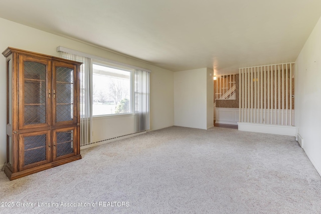 empty room with carpet and baseboard heating