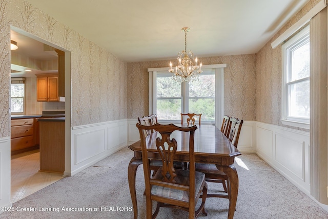 dining space featuring wallpapered walls and a wealth of natural light