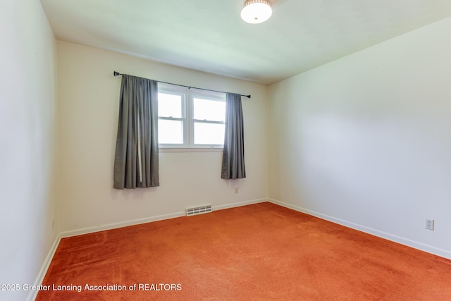 spare room featuring visible vents, baseboards, and carpet floors