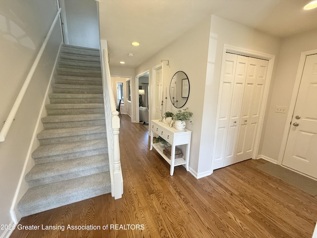stairs featuring baseboards, recessed lighting, and wood finished floors
