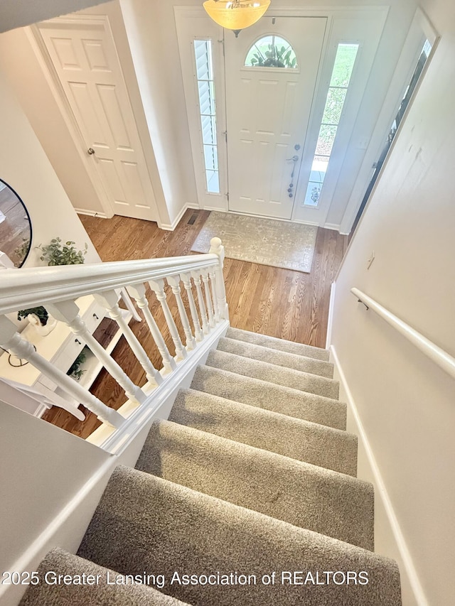 entryway featuring wood finished floors and stairway