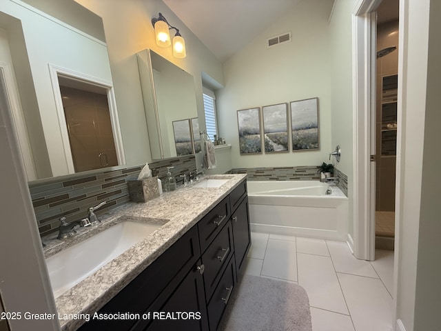 bathroom featuring a sink, tile patterned flooring, vaulted ceiling, and visible vents