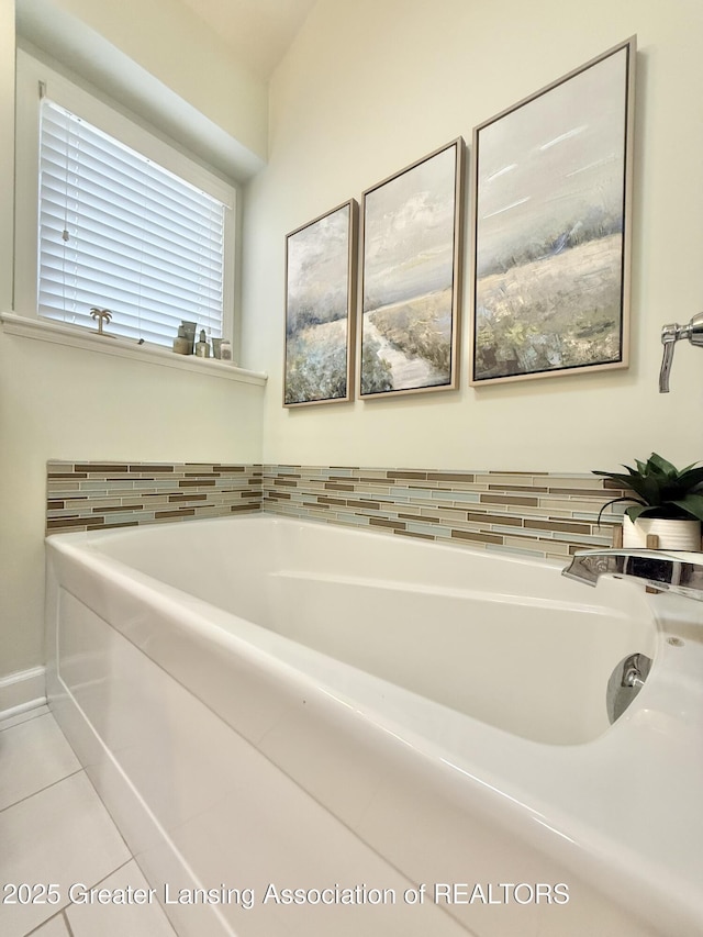 bathroom featuring tile patterned flooring and a bath