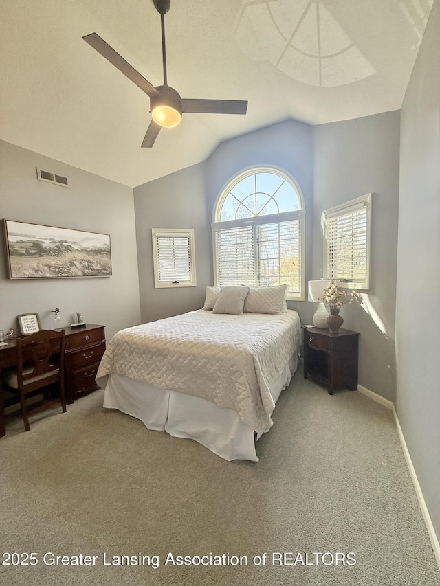 carpeted bedroom with visible vents, baseboards, ceiling fan, and lofted ceiling
