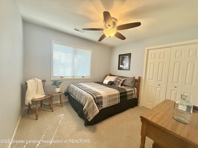 bedroom with ceiling fan, visible vents, baseboards, a closet, and carpet flooring