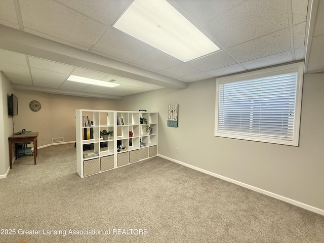 interior space with baseboards, visible vents, and a paneled ceiling