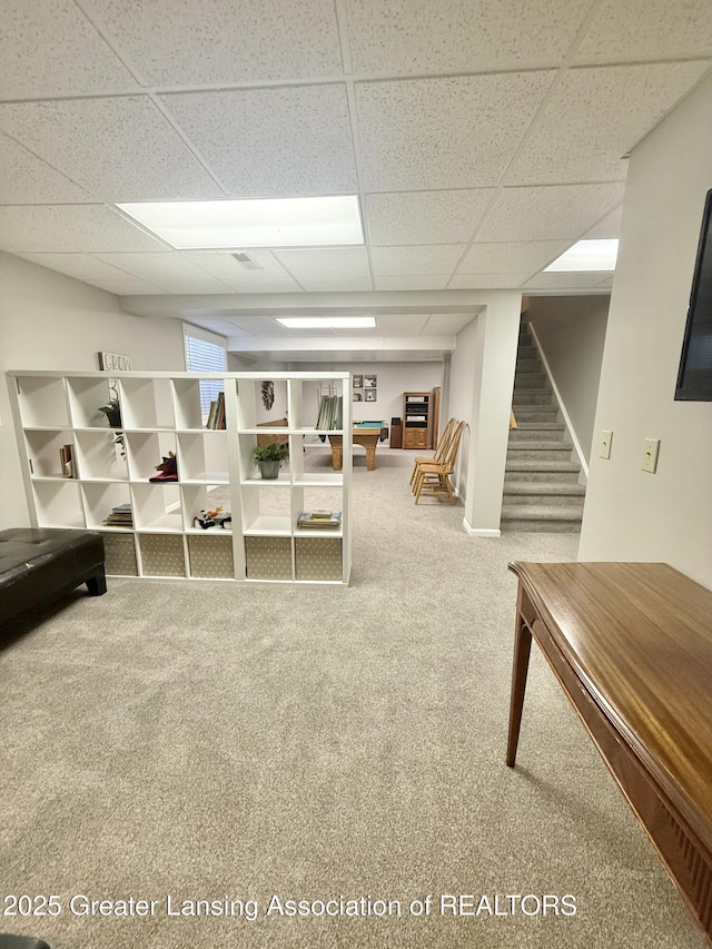 interior space with carpet floors, a paneled ceiling, and stairway