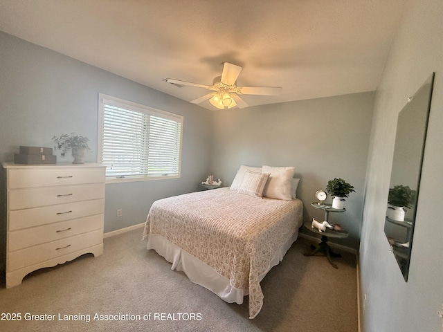 bedroom with baseboards, ceiling fan, and light colored carpet