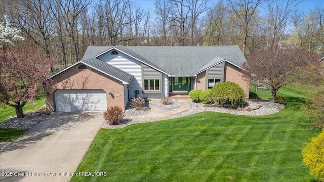 single story home with a garage, brick siding, a front lawn, concrete driveway, and a shingled roof