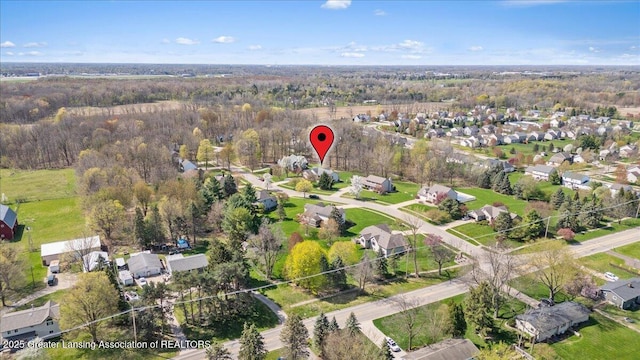 drone / aerial view with a view of trees and a residential view