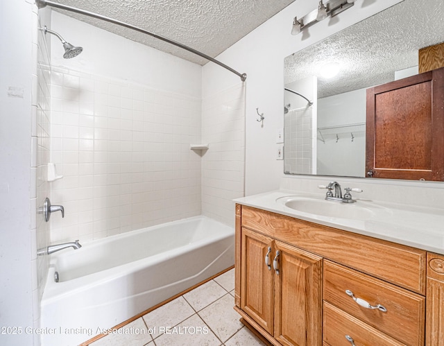 bathroom with tile patterned flooring, a textured ceiling, shower / bath combination, and vanity