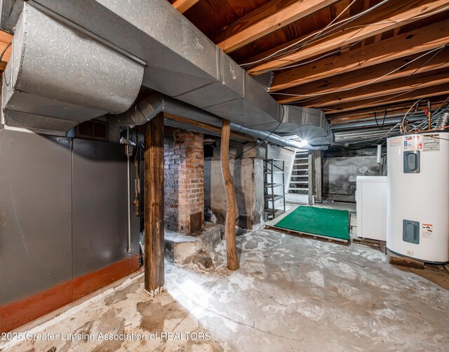 unfinished basement featuring stairs, washer / clothes dryer, and electric water heater