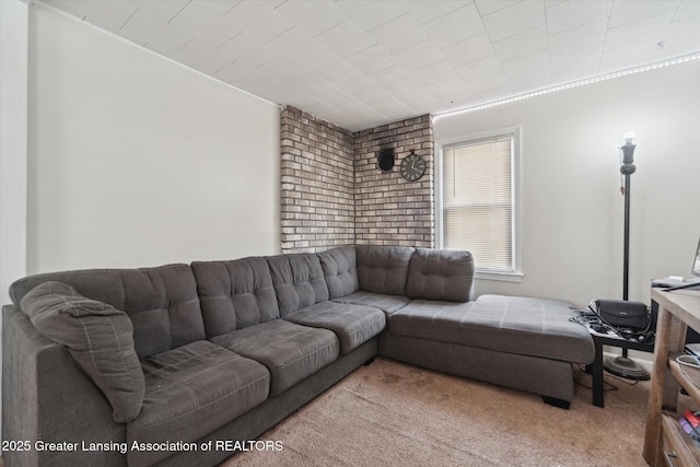 carpeted living area with ornamental molding and brick wall