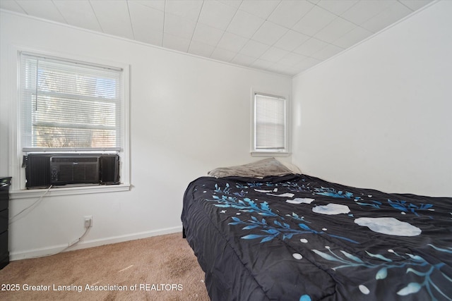 carpeted bedroom featuring baseboards, ornamental molding, and cooling unit