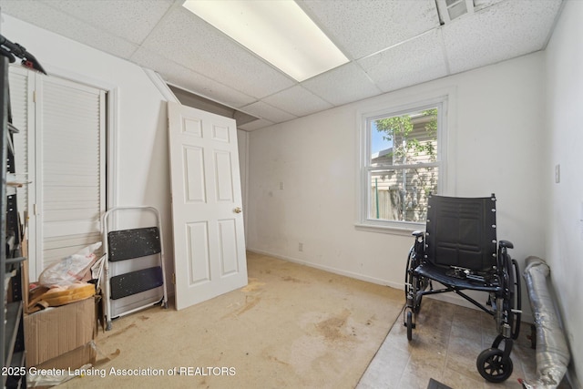 office area featuring baseboards and a paneled ceiling