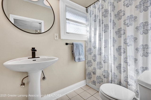 bathroom with baseboards, tile patterned floors, a shower with curtain, and toilet