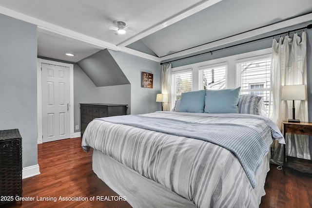 bedroom featuring wood finished floors, baseboards, and lofted ceiling