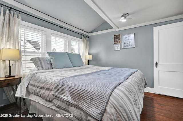 bedroom featuring baseboards, wood finished floors, and vaulted ceiling