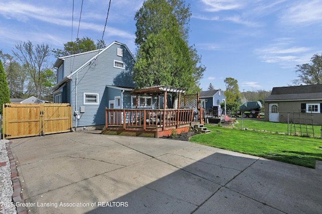 back of house featuring a yard, a pergola, fence, and a deck