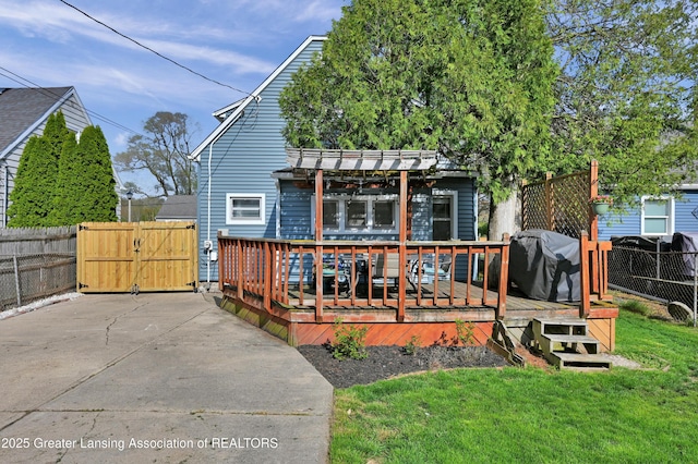 exterior space featuring fence, a pergola, a wooden deck, a gate, and a yard