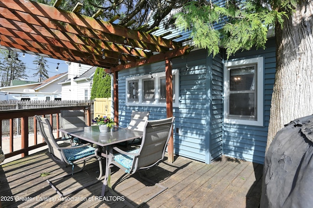 deck featuring fence, a pergola, and outdoor dining area