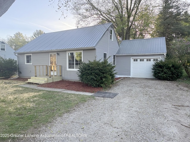 6301 Cooper Rd, Lansing, MI 48911 - view of front of property featuring an attached garage, an outbuilding, metal roof, and gravel driveway